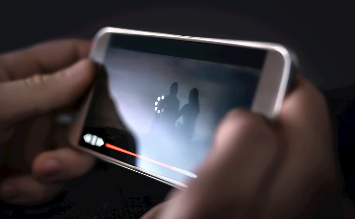 An Android smartphone showing a video playback buffering stutter on screen